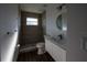 Bathroom with step-in shower, vanity and round mirror at 2271 Alton Rd, Port Charlotte, FL 33952