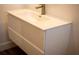 Bathroom featuring a modern vanity with sleek white cabinets and a stainless steel faucet at 2271 Alton Rd, Port Charlotte, FL 33952