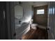 Bathroom with tiled walk-in shower, round mirror, and modern vanity at 2271 Alton Rd, Port Charlotte, FL 33952