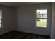 Bedroom with hardwood floors and windows showing the outdoors at 2271 Alton Rd, Port Charlotte, FL 33952