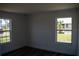 Clean, bright bedroom with dual windows offering pleasant views of the outdoors at 2271 Alton Rd, Port Charlotte, FL 33952