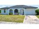 Charming single-story home with stucco exterior, arched entryway, and well-maintained lawn at 2271 Alton Rd, Port Charlotte, FL 33952