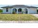 Lovely single-story home showcasing a manicured lawn and a convenient one-car attached garage at 2271 Alton Rd, Port Charlotte, FL 33952