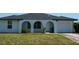 Charming home featuring an arched entryway and well-maintained landscaping at 2271 Alton Rd, Port Charlotte, FL 33952