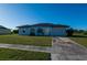Charming single-story home with a well-manicured lawn, a driveway, and an attached garage at 2271 Alton Rd, Port Charlotte, FL 33952