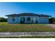 Inviting single-story home featuring arched entryways, a lush lawn, and attached one-car garage at 2271 Alton Rd, Port Charlotte, FL 33952