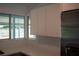 Modern kitchen with white cabinets, stainless steel refrigerator, and view of a screened patio at 2271 Alton Rd, Port Charlotte, FL 33952
