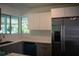 Updated kitchen features gray cabinets, stainless steel appliances, and plenty of natural light at 2271 Alton Rd, Port Charlotte, FL 33952