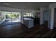 Open-concept kitchen featuring stainless steel appliances and an island with quartz countertops at 2271 Alton Rd, Port Charlotte, FL 33952