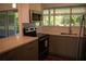 Renovated kitchen boasts stainless steel appliances, modern cabinets, and a stylish backsplash at 2271 Alton Rd, Port Charlotte, FL 33952
