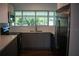 Modern kitchen features sleek gray cabinets, stainless steel appliances, and ample counter space at 2271 Alton Rd, Port Charlotte, FL 33952