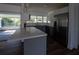 Bright kitchen with a breakfast bar, stainless steel refrigerator, and a view of the screened patio at 2271 Alton Rd, Port Charlotte, FL 33952