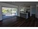 Spacious kitchen with stainless steel appliances, peninsula seating, and a screened lanai in the background at 2271 Alton Rd, Port Charlotte, FL 33952