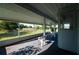 Screened lanai offering serene view of the green backyard and tranquil water feature at 2271 Alton Rd, Port Charlotte, FL 33952