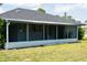 Enclosed lanai has seating area that's perfect for entertaining or relaxing with serene backyard views at 2271 Alton Rd, Port Charlotte, FL 33952