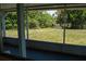 Serene view of the backyard and water feature from the screened lanai, offering a peaceful retreat at 2271 Alton Rd, Port Charlotte, FL 33952