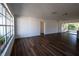 Spacious living room with modern wood flooring and lots of natural light through large windows at 2271 Alton Rd, Port Charlotte, FL 33952