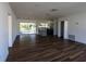 The open concept integrates the kitchen, dining, and living room with modern laminate wood flooring at 2271 Alton Rd, Port Charlotte, FL 33952