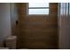 Bathroom featuring a fully-tiled shower with a window and modern fixtures at 2271 Alton Rd, Port Charlotte, FL 33952