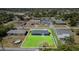 An aerial view displays a blue home with a large lawn in a quiet, residential neighborhood at 2420 Linton Ln, Port Charlotte, FL 33952