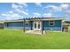A pergola stands outside the french doors of this home, providing shade and style to the backyard at 2420 Linton Ln, Port Charlotte, FL 33952