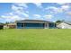 The backyard has a well-manicured lawn, perfect for outdoor activities and relaxing in the sunshine at 2420 Linton Ln, Port Charlotte, FL 33952