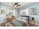 Bedroom with a modern color palette, ceiling fan, two windows, and stylish décor at 2420 Linton Ln, Port Charlotte, FL 33952