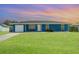 This cozy home has a well-kept front yard and a one-car garage for convenience at 2420 Linton Ln, Port Charlotte, FL 33952