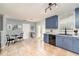 Bright kitchen featuring blue cabinets, stainless appliances, and a breakfast table set near french doors at 2420 Linton Ln, Port Charlotte, FL 33952