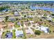 Scenic aerial view of a residential area with homes nestled amongst green spaces and a serene lake at 25379 Paladin Ln, Punta Gorda, FL 33983