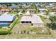 Aerial view of a fenced-in backyard with landscaping, showcasing the home's setting in a residential neighborhood at 25379 Paladin Ln, Punta Gorda, FL 33983