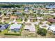 Aerial shot of houses with driveways and well-kept yards in a quiet neighborhood near a lake at 25379 Paladin Ln, Punta Gorda, FL 33983