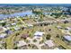 Panoramic aerial view of houses near a beautiful lake, surrounded by trees and lush greenery at 25379 Paladin Ln, Punta Gorda, FL 33983