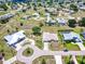 Aerial view of a single-Gathering home community featuring well-maintained lawns, mature trees, and circular driveways at 25379 Paladin Ln, Punta Gorda, FL 33983