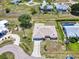 Aerial view of a home showcasing a circular driveway, spacious backyard, and well-maintained landscaping, including mature palm trees at 25379 Paladin Ln, Punta Gorda, FL 33983