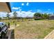 Spacious backyard with a built-in grill, rock border, palm trees and secure fence ensuring privacy and a peaceful outdoor setting at 25379 Paladin Ln, Punta Gorda, FL 33983