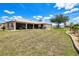 A spacious backyard with mature landscaping and a screened lanai, perfect for outdoor entertaining and relaxation at 25379 Paladin Ln, Punta Gorda, FL 33983