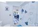 Updated bathroom featuring a shower with fun decor, and a view to dining area at 25379 Paladin Ln, Punta Gorda, FL 33983
