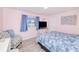 Cozy bedroom features a comfortable bed, chair, and large window at 25379 Paladin Ln, Punta Gorda, FL 33983