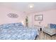 Comfortable bedroom featuring a desk, patterned chair, and nice decor at 25379 Paladin Ln, Punta Gorda, FL 33983