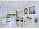 Bright dining area adjacent to the living room, featuring a modern chandelier and outdoor views at 25379 Paladin Ln, Punta Gorda, FL 33983