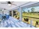 Enclosed Florida room with a beautiful view of the garden and blue accents in the decorations and the floor at 25379 Paladin Ln, Punta Gorda, FL 33983