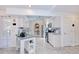Spacious kitchen has stainless appliances, white cabinets, island prep area, and open access to other rooms at 25379 Paladin Ln, Punta Gorda, FL 33983