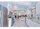 Bright open kitchen features a large island, modern appliances, white cabinets, and lots of natural light at 25379 Paladin Ln, Punta Gorda, FL 33983