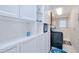 Well-organized laundry room offers ample storage in the built-in white cabinets and a modern washer/dryer at 25379 Paladin Ln, Punta Gorda, FL 33983