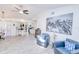 Open living room featuring sofa seating, adjacent office area, artwork, and plenty of natural light at 25379 Paladin Ln, Punta Gorda, FL 33983