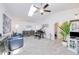 Open living room features a skylight, piano, lots of seating, and access to other rooms at 25379 Paladin Ln, Punta Gorda, FL 33983