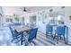 Inviting outdoor patio features a dining area, bar seating, and a ceiling fan to keep you cool at 25379 Paladin Ln, Punta Gorda, FL 33983