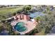 Aerial view of community pool and tennis courts with golf course in the distance at 26111 Feathersound Dr, Punta Gorda, FL 33955