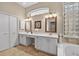 Elegant bathroom with a double vanity, framed mirrors, and plenty of storage at 26111 Feathersound Dr, Punta Gorda, FL 33955